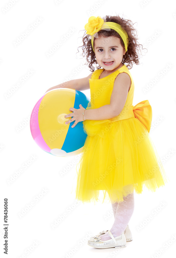 elegant, dark-haired little girl in a yellow dress and a ball in elegant, dark-haired little girl in a yellow dress and a ball in