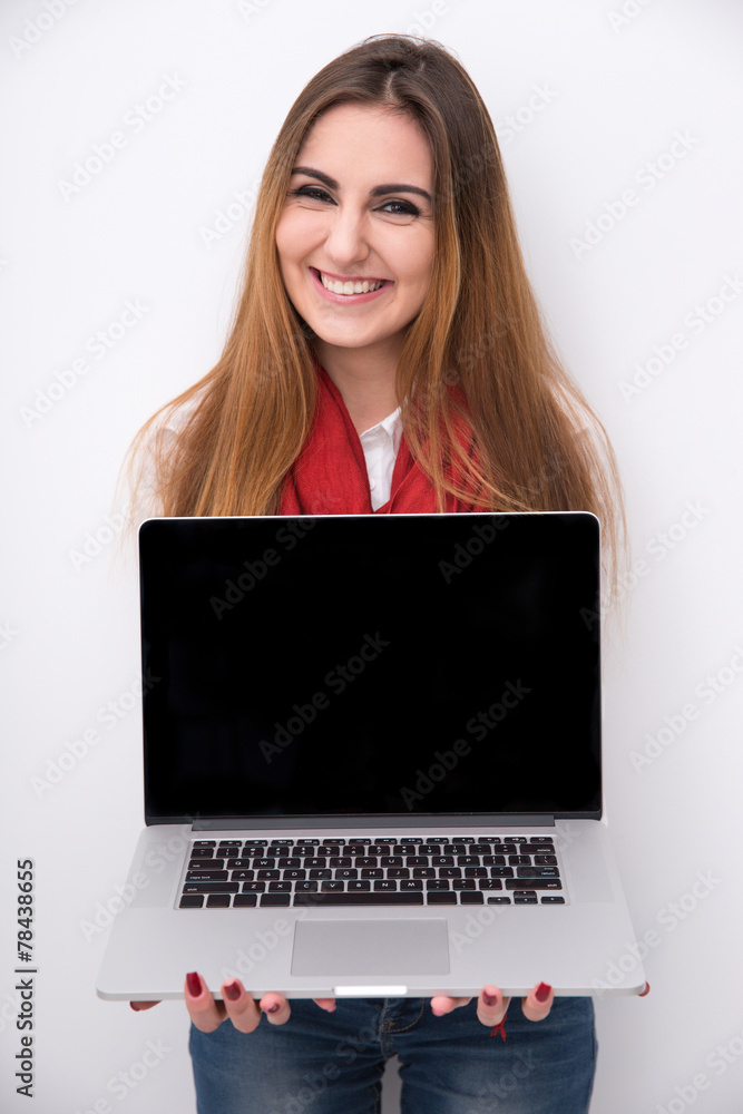 Cheerful beautiful woman showing blank laptop screen Cheerful beautiful woman showing blank laptop screen