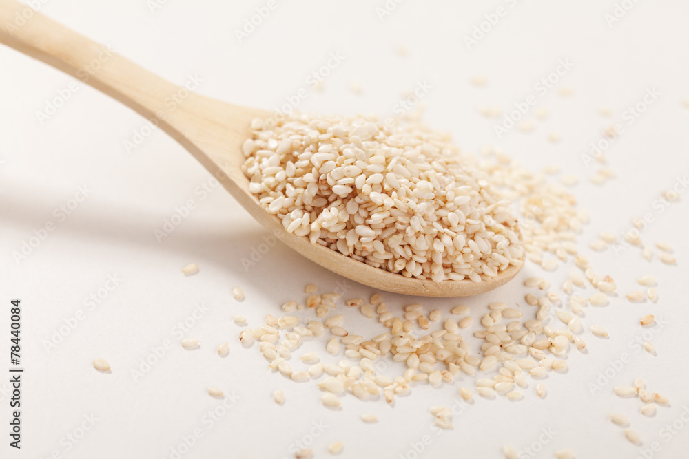 Sesame seeds in a wooden spoon Sesame seeds in a wooden spoon