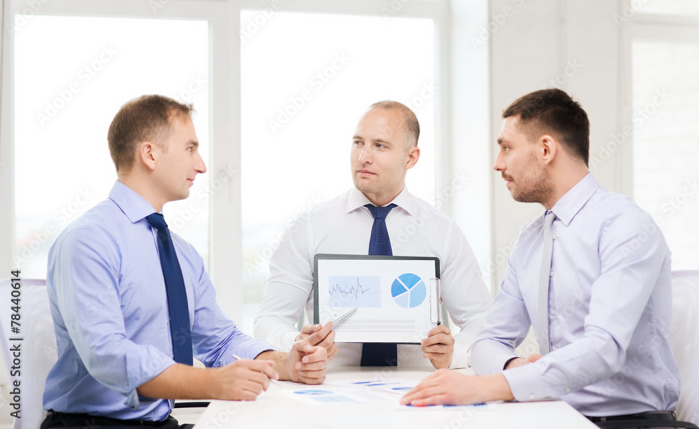 serious businessmen with papers in office serious businessmen with papers in office