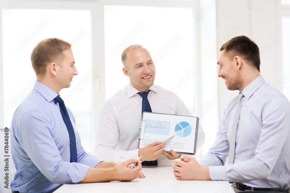 smiling businessmen with papers in office smiling businessmen with papers in office