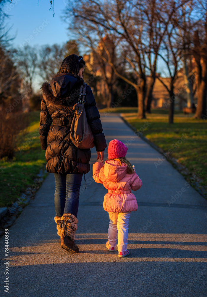 Fototapeta premium Mother and Daughter walk on a sunny winter day