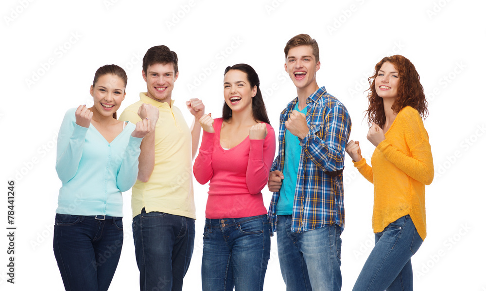 group of smiling teenagers showing triumph gesture group of smiling teenagers showing triumph gesture