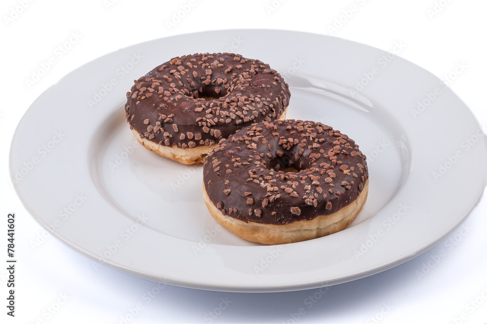Two ring donuts with chololate glaze on white plate