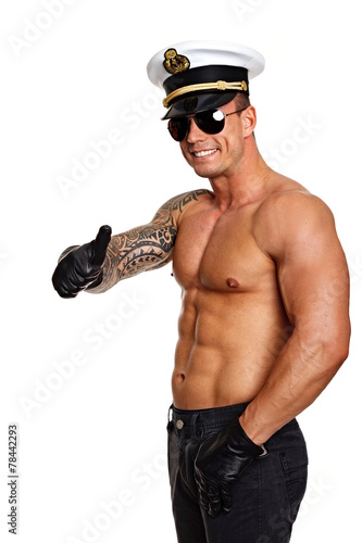 Man in captain cap with sunglasses shows you thumb up