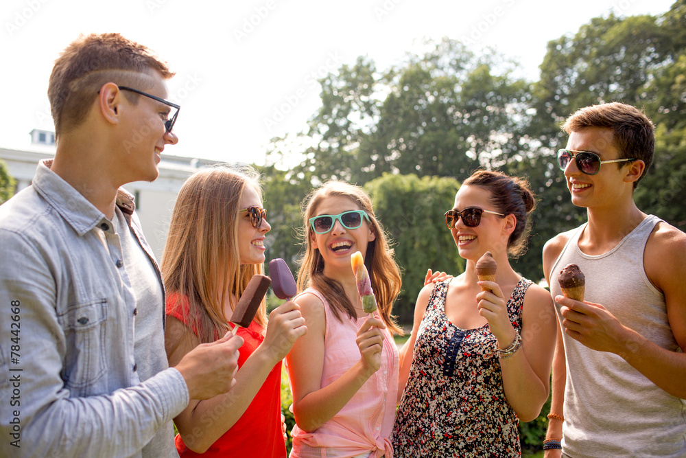 group of smiling friends with ice cream outdoors