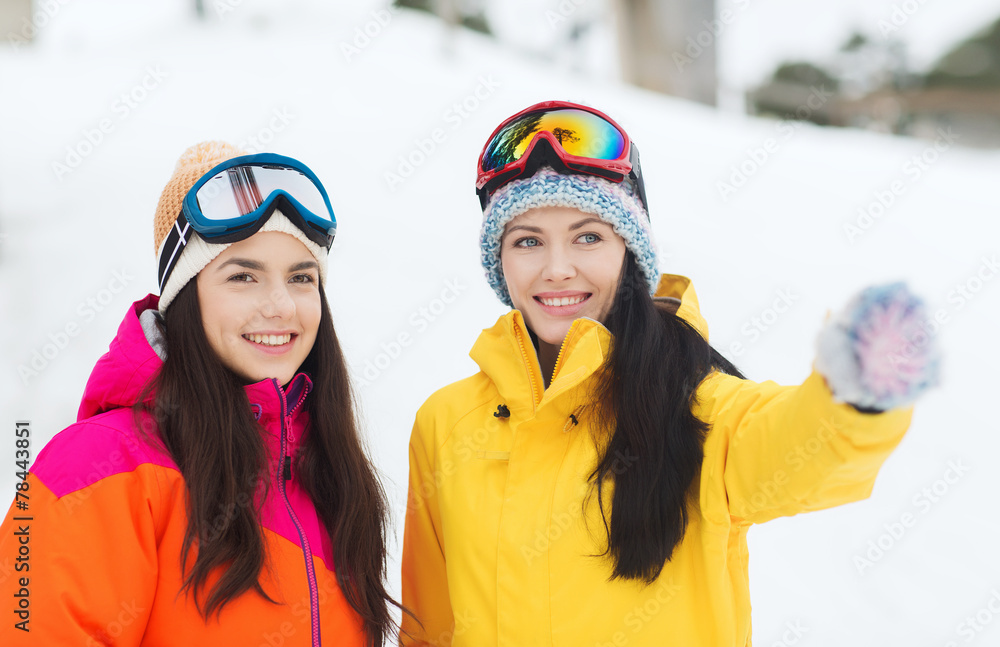 happy girl friends in ski goggles outdoors happy girl friends in ski goggles outdoors