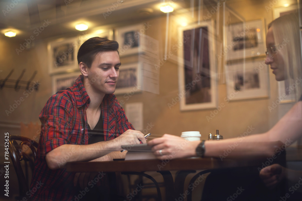 Couple is having a date in cafe. They drink coffee tea and talk Couple is having a date in cafe. They drink coffee tea and talk