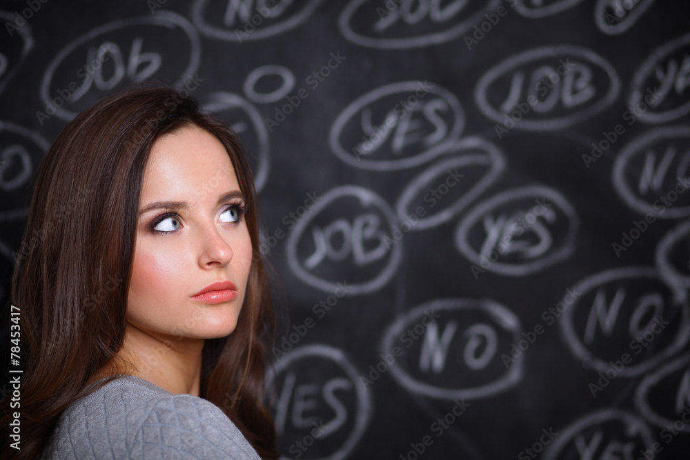 Thinking young woman with yes or no choice on grey background Thinking young woman with yes or no choice on grey background
