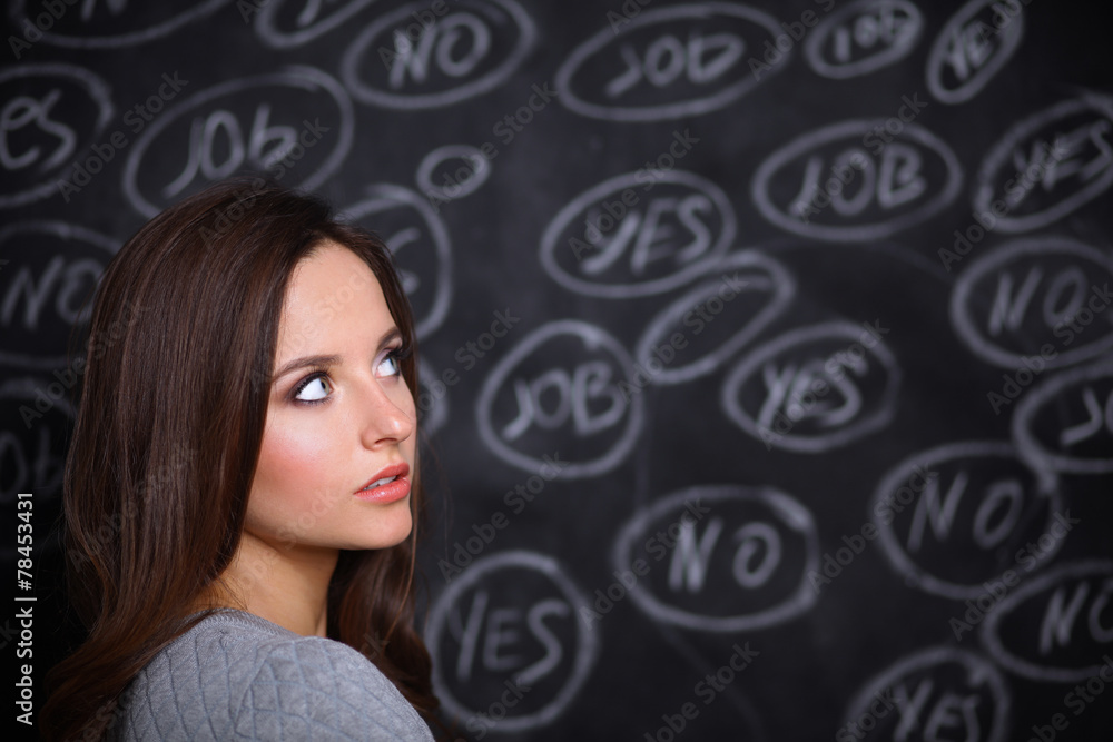 Thinking young woman with yes or no choice on grey background Thinking young woman with yes or no choice on grey background