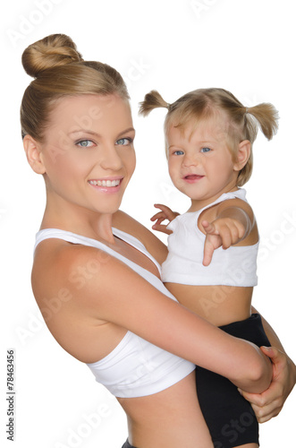 Mother with her daughter in yoga clothes