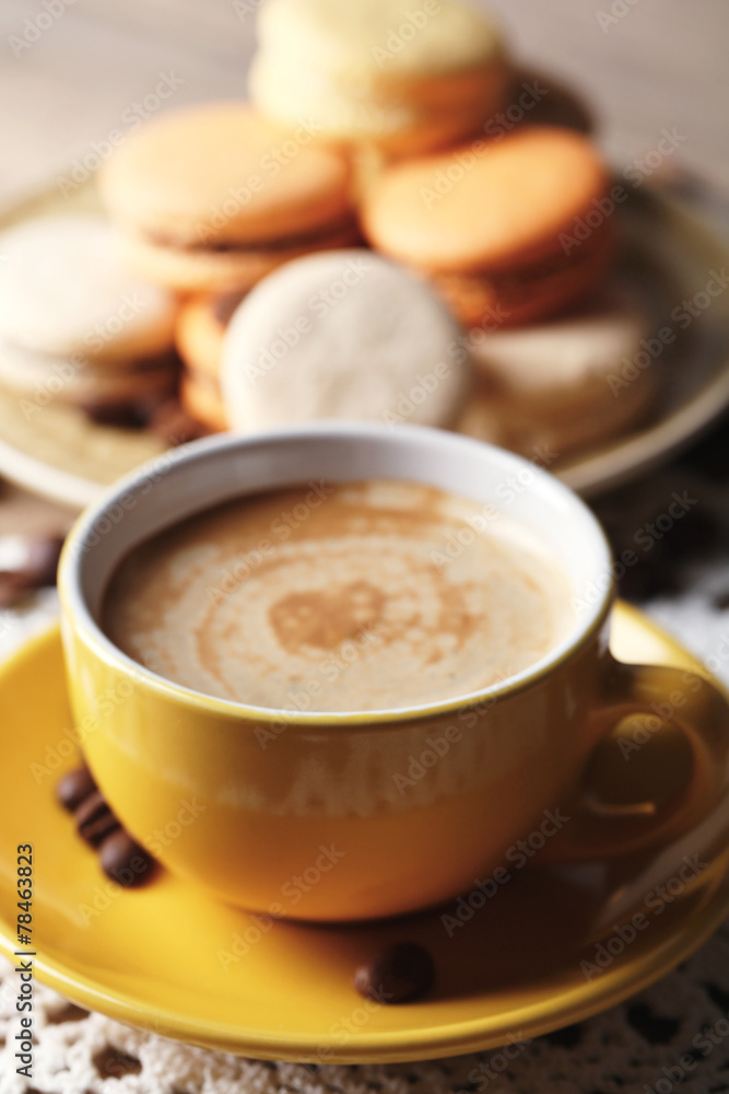 Gentle colorful macaroons and coffee in mug Gentle colorful macaroons and coffee in mug