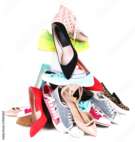 Pile of various female shoes isolated on white