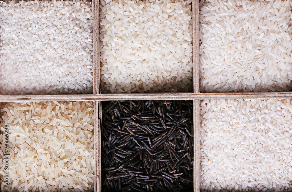 Fototapeta premium Different types of rice in box on wooden background