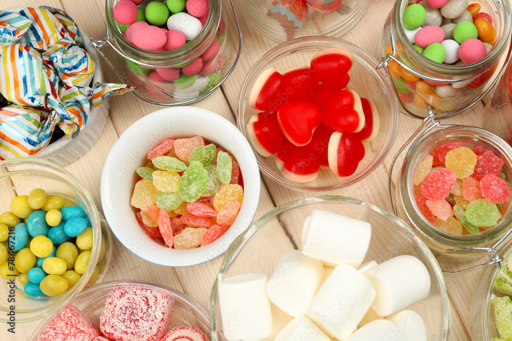 Sweetness in different containers on wooden background Sweetness in different containers on wooden background