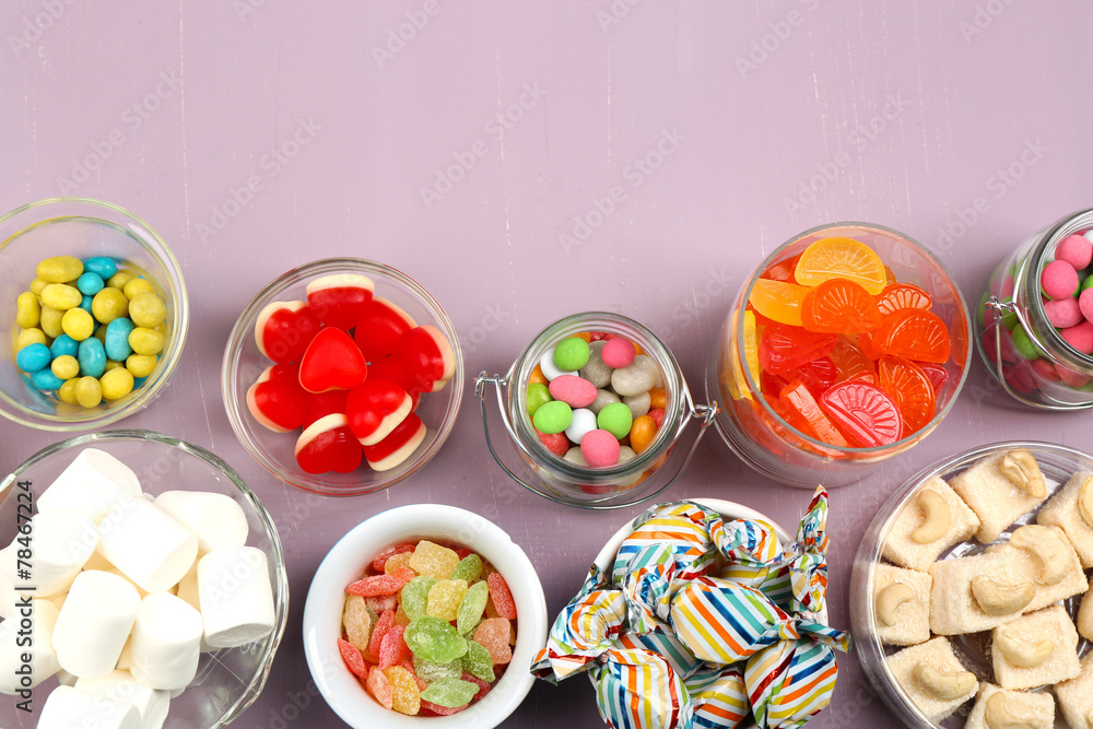 Sweetness in different containers on wooden background Sweetness in different containers on wooden background