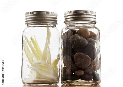 One jar of rocks and one of feathers.