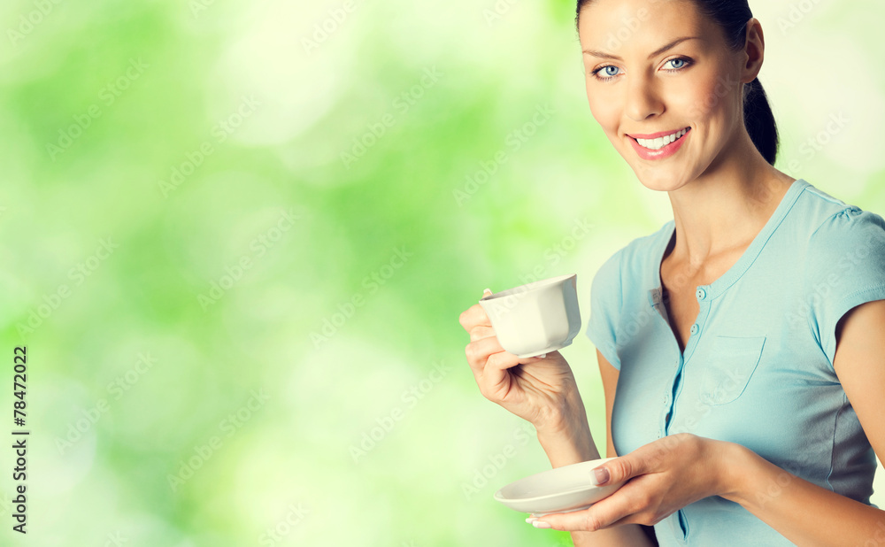 Portrait of smiling young woman drinking coffee Portrait of smiling young woman drinking coffee