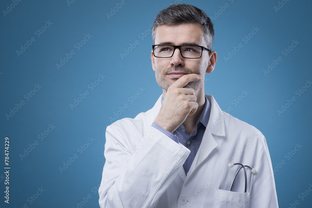 Pensive doctor with hand on chin Pensive doctor with hand on chin