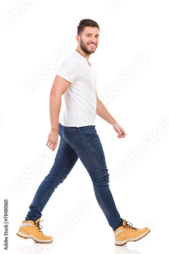 Young man marching in jeans and white t-shirt