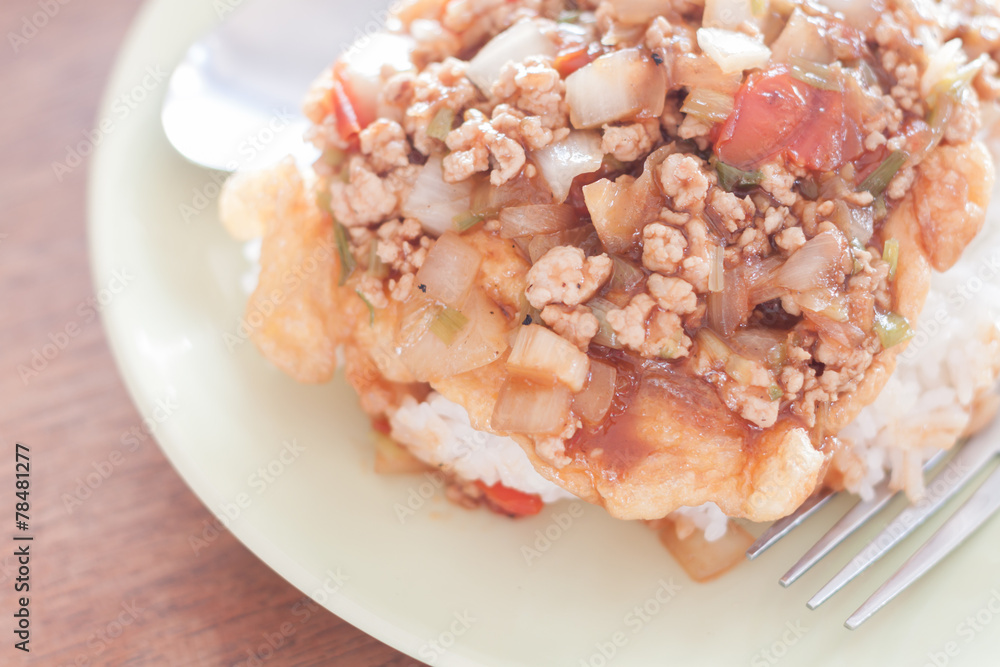 Fried pork with tomato sauce topping on fried egg Fried pork with tomato sauce topping on fried egg