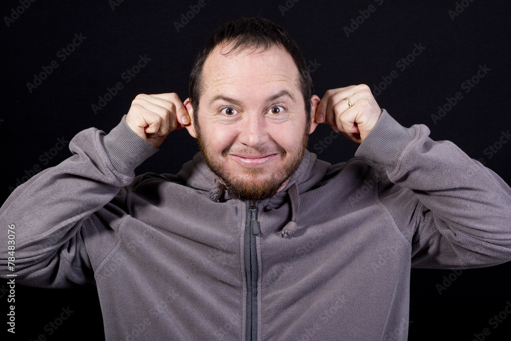 Naklejka premium man pulling his ears isolated on black background