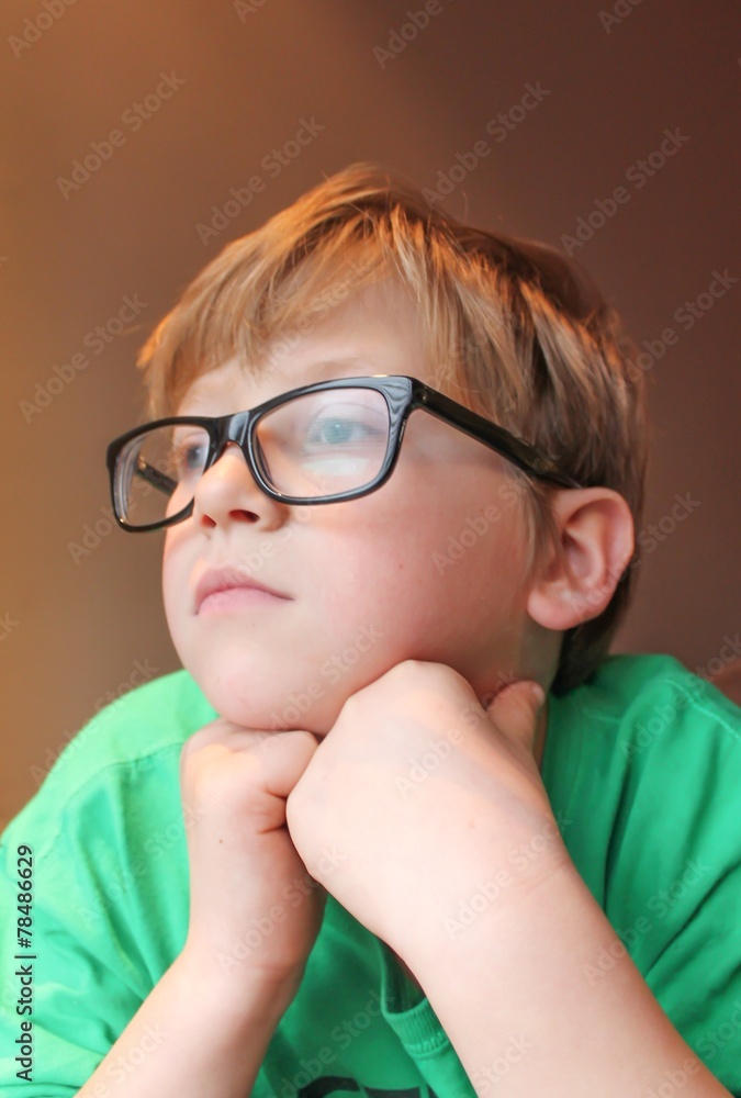 Young pensive boy in glasses