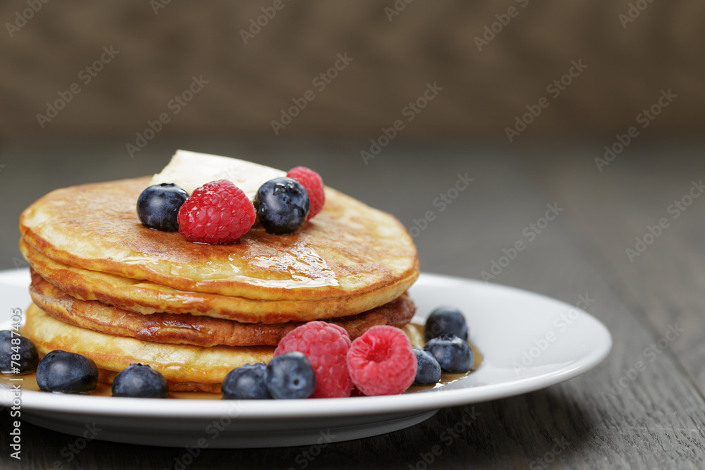 Classic pancakes with butter berrys and maple syrup Classic pancakes with butter berrys and maple syrup