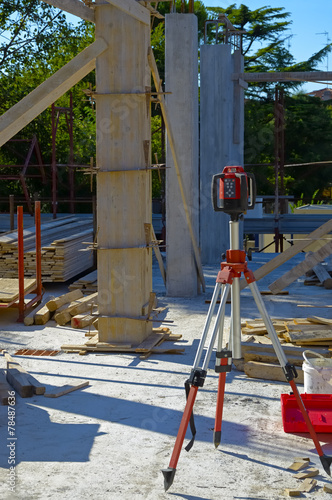 Electronic level on a tripod set up at a construction site