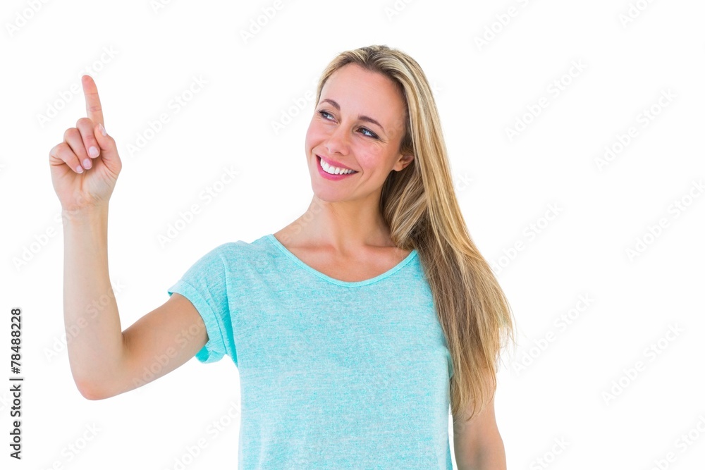 Fototapeta premium Portrait of smiling blonde pointing up
