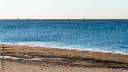 frozen beach near shipyard and sea port