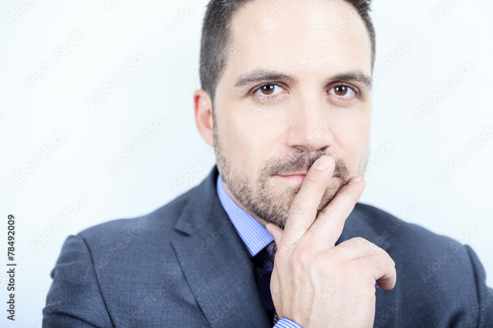 A beautiful business man standing against grey background A beautiful business man standing against grey background