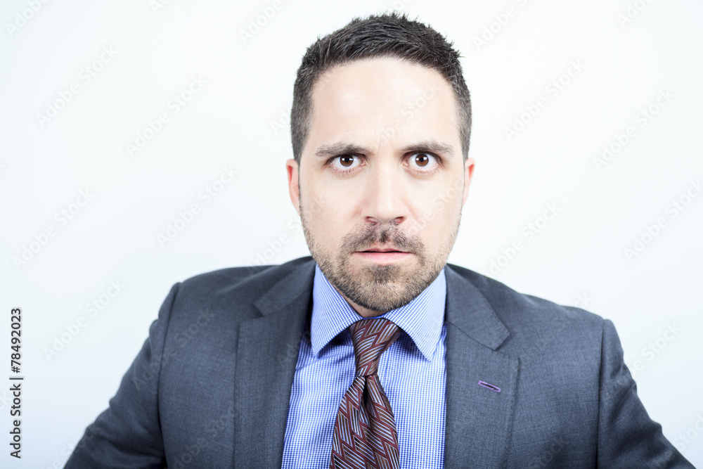 A beautiful business man standing against grey background A beautiful business man standing against grey background