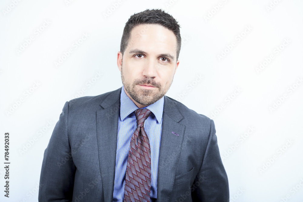 A beautiful business man standing against grey background A beautiful business man standing against grey background