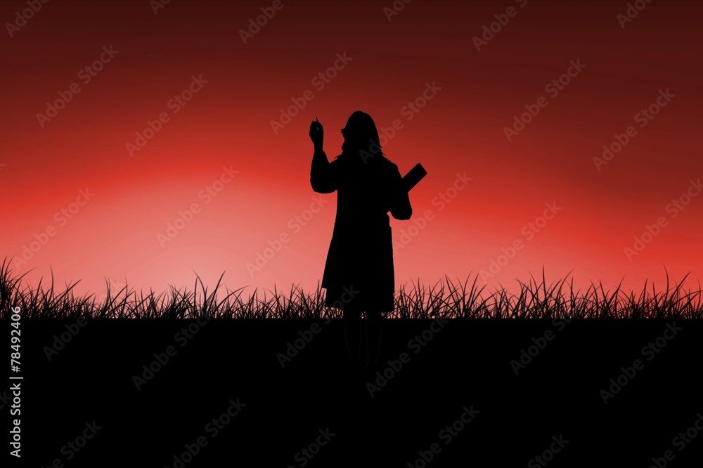 Composite image of silhouette of doctor pointing with pen