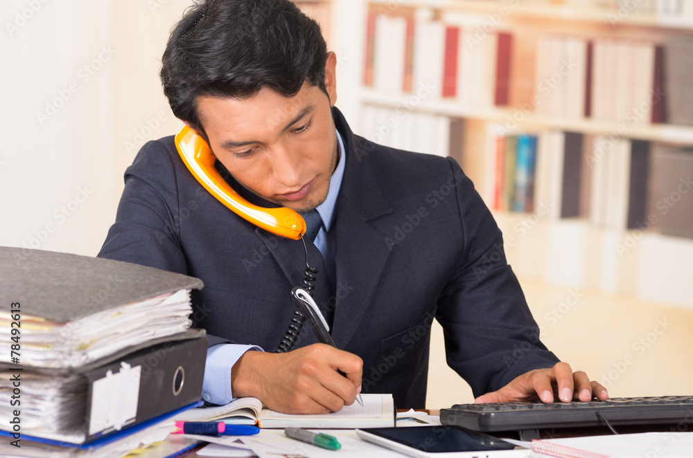 young stressed overwhelmed man with piles of folders on his desk young stressed overwhelmed man with piles of folders on his desk