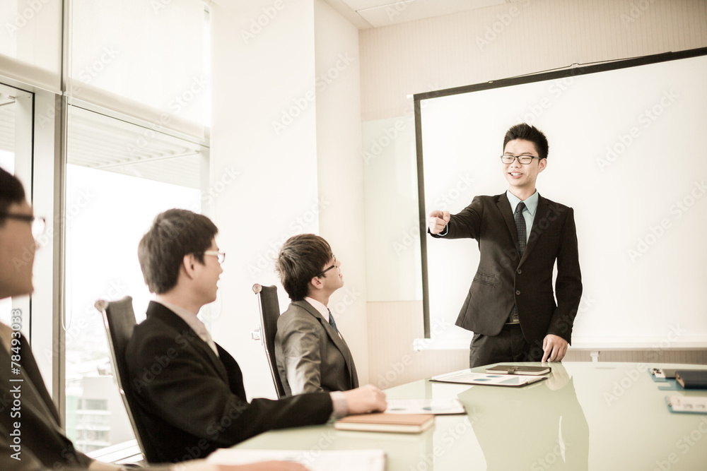 businessman giving a presentation to his colleagues businessman giving a presentation to his colleagues