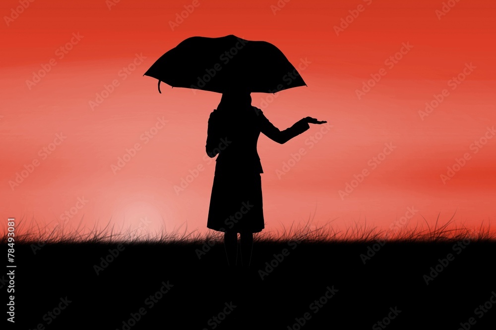 Composite image of silhouette of businesswoman holding umbrella