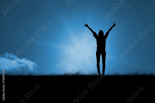 Composite image of silhouette of cheering woman