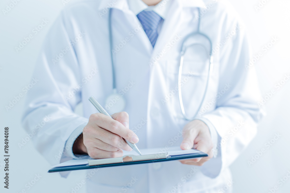 Close-up of male hands filling in medical form Close-up of male hands filling in medical form