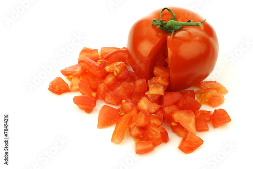 fresh tomato with pieces coming out on a white background