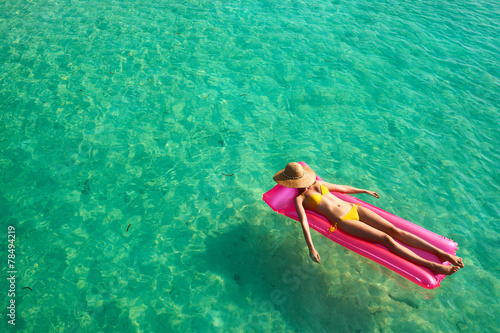 Woman relaxing on inflatable mattress