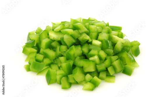 cut pieces of green paprika (capsicum) on a white background