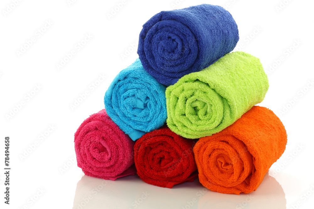 rolled up and stacked bathroom towels on a white background rolled up and stacked bathroom towels on a white background