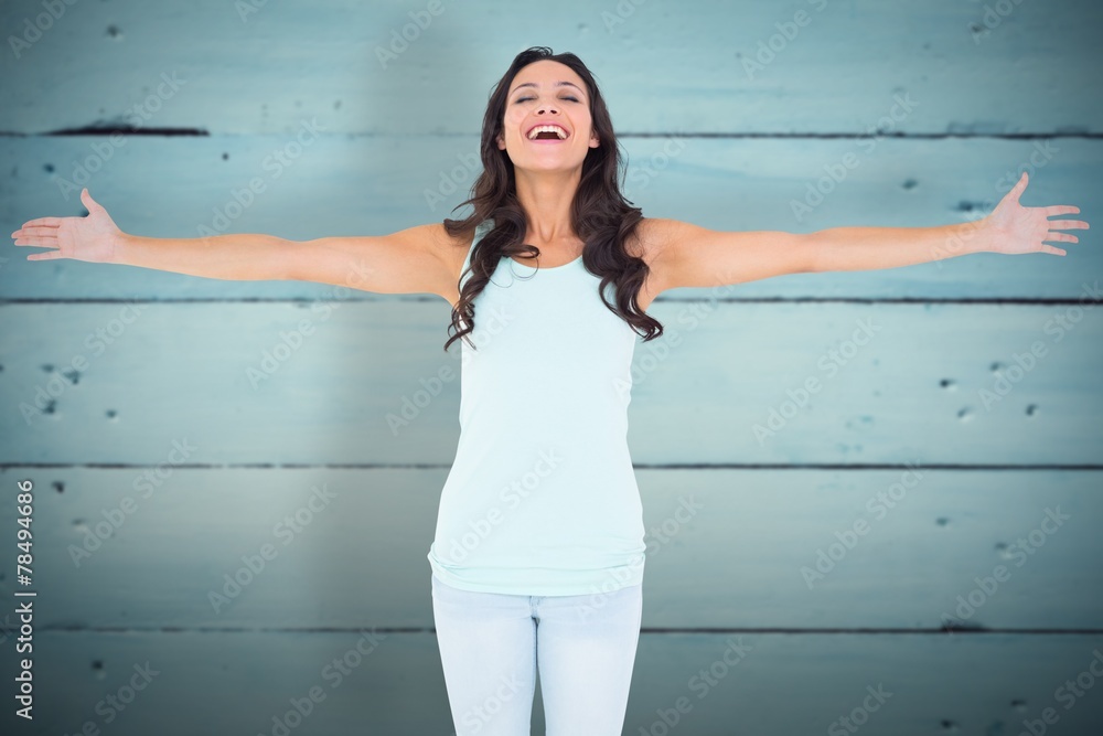 Composite image of carefree brunette with arms out