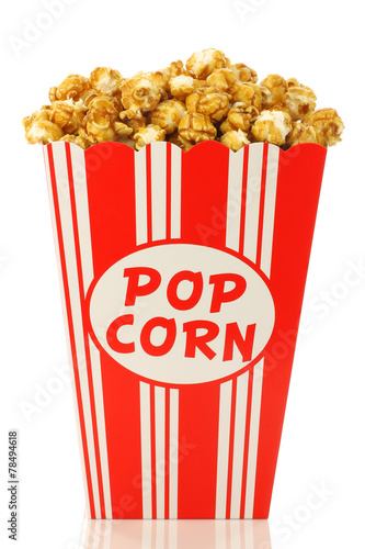 caramel popcorn in a paper popcorn cup on a white background