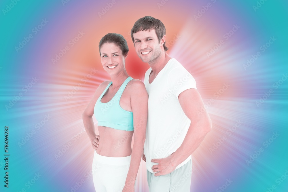 Composite image of fit couple smiling at camera Composite image of fit couple smiling at camera