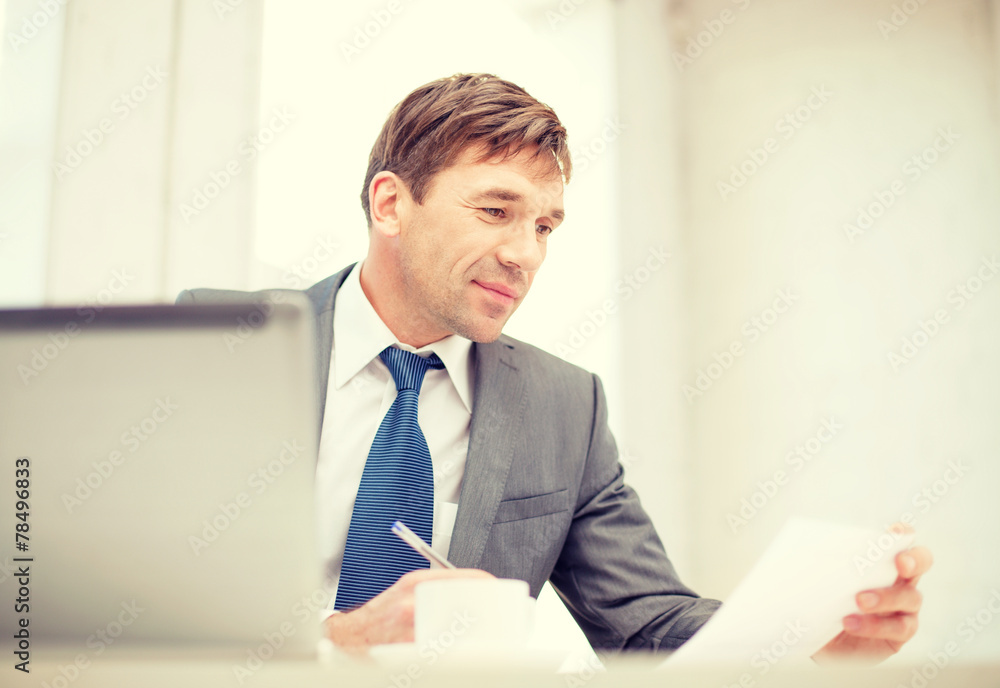 businessman with laptop computer and documents
