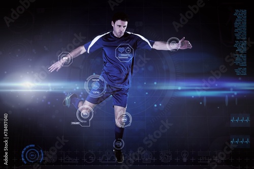 Composite image of football player in blue kicking © WavebreakMediaMicro