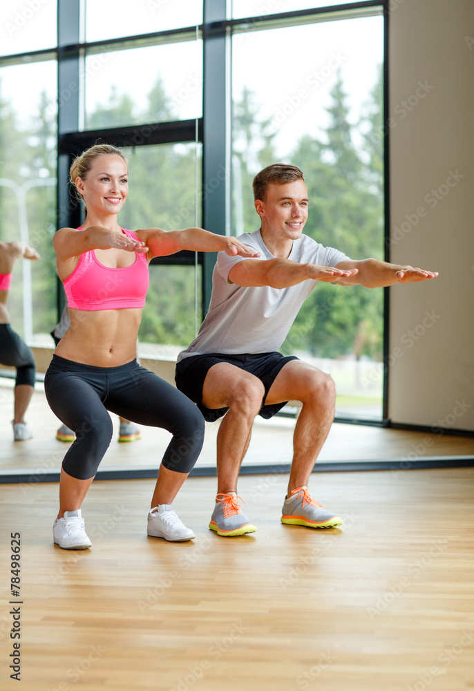 smiling man and woman in gym
